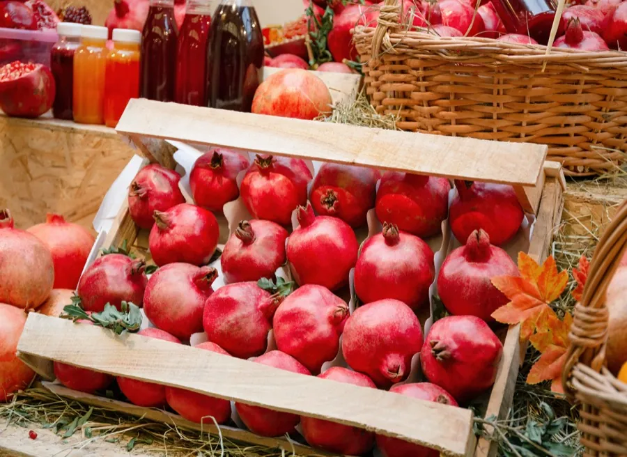 Pomegranates packed in wooden crates at a produce market