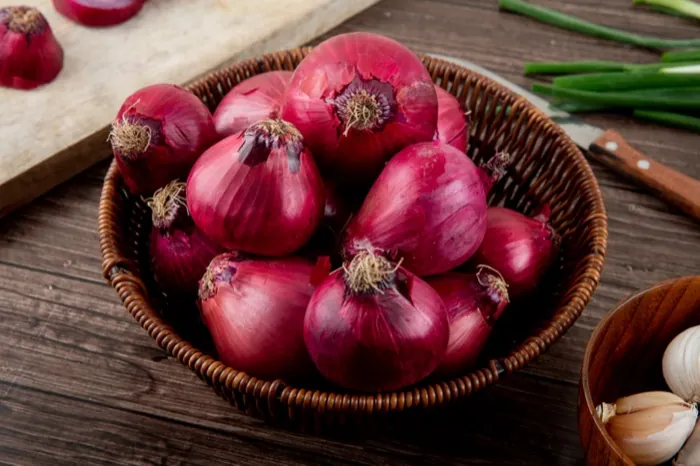 Fresh red onions in a basket