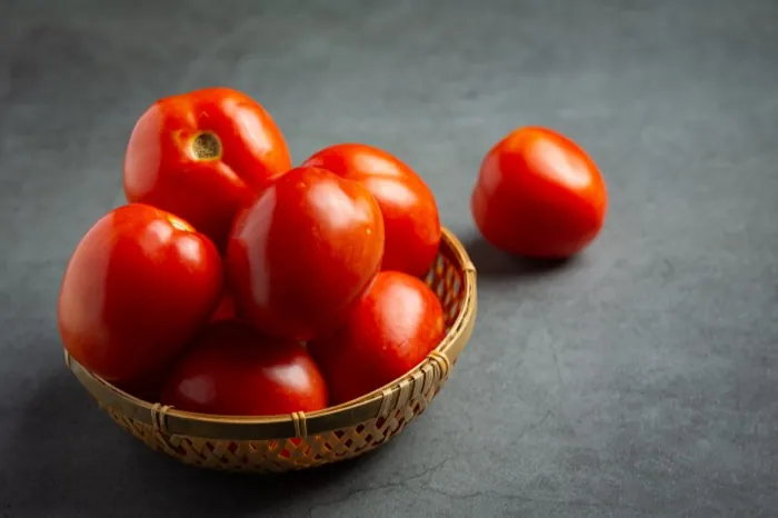 Firm red tomatoes in crate